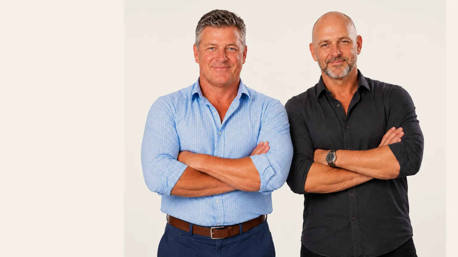 Barry and Dave, arms folded, on a white studio background