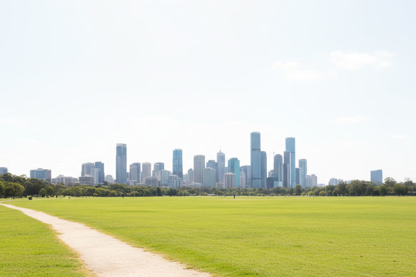 An open path across a Brisbane park leading toward the distant skyline, suggesting a journey already well underway before most people noticed.